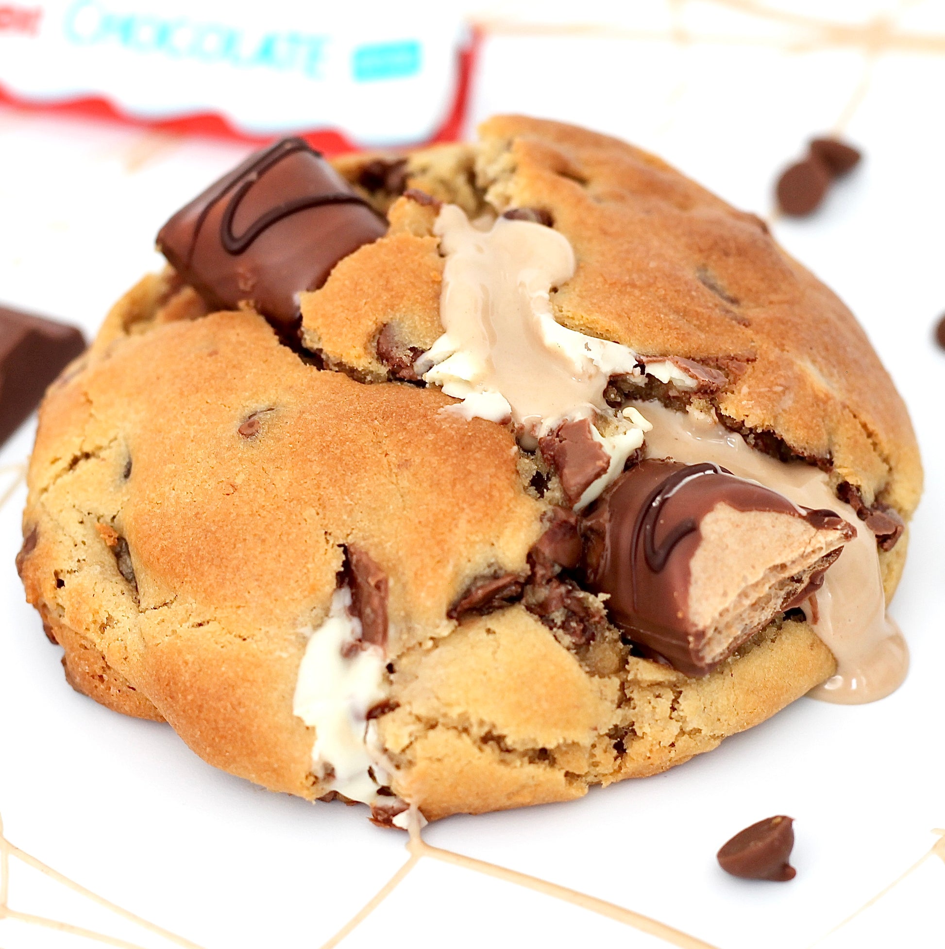 Order The Bella Kinderella from Dolly's Dough: Baked fresh New York-style cookies packed with Belgian chocolate and Kinder pieces, delivered with Tracked 24.